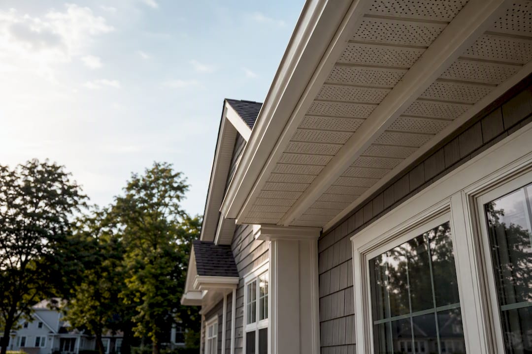 Continuous vented soffit along roof eaves