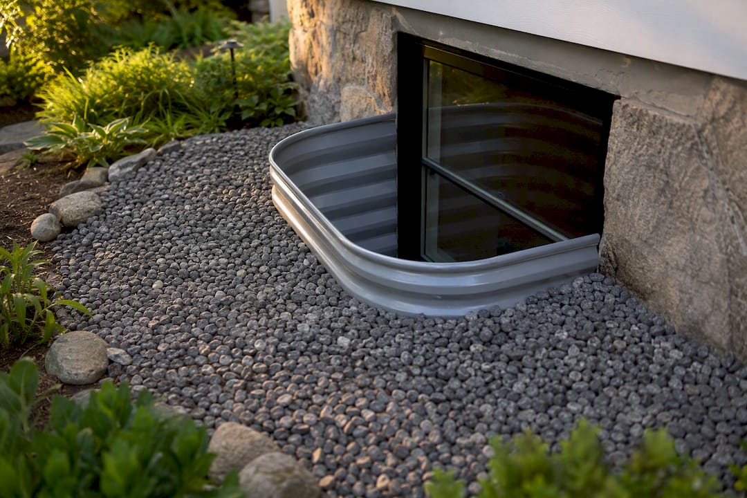 Close-up of window well gravel drainage